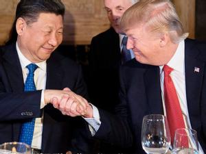 https://www.ajot.com/images/uploads/article/Donald-Trump-Xi-Jinping-handshake-Florida.jpeg