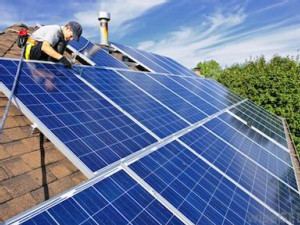 https://www.ajot.com/images/uploads/article/solar-panels-being-installed-on-a-residential-roof.jpg