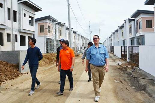 Noel Monzon, MICT Gates & Roads Operations Customs Manager (center) and Jose Carlo Javier (right), MICT HR Director, inspect the construction of houses at PHirst Park Homes in Tanza, Cavite.