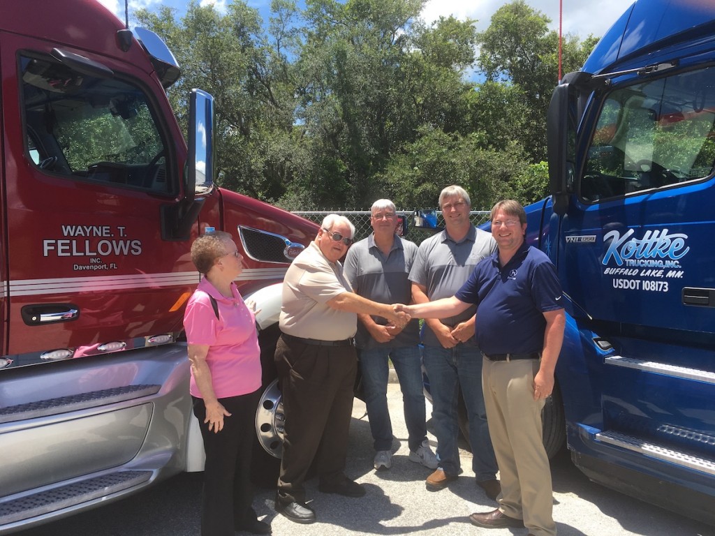 From left to right: Wayne T. Fellows owners Sue Fellows and Tom Fellows. Tom is shaking hands with Kottke Trucking co-owner Kyle Kottke. From left to right, between Tom and Kyle, Kottke Trucking co-owners, Kurt Kottke and Kory Kottke.