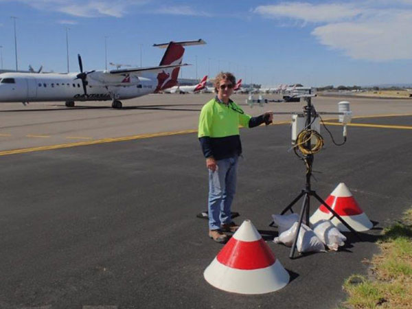 SA Water Environmental Opportunities Manager Greg Ingleton testing tarmac temperature at Adelaide Airport during the trial.