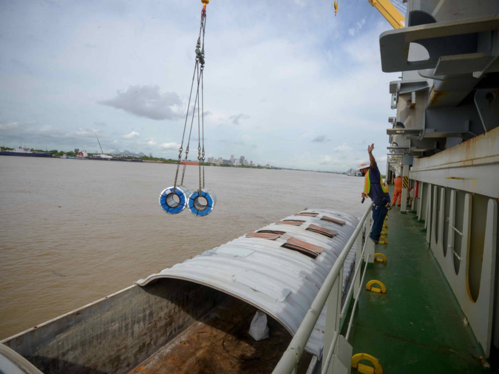 Steel coils being transferred ship to barge at Alabo Street Wharf.