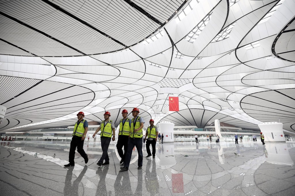 Workers walk through the terminal building. Photographer: STR/AFP via Getty Images