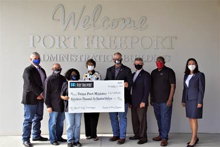 Port Freeport Commission and staff present check to Bobby Fuller, Director of Texas Port Ministry.