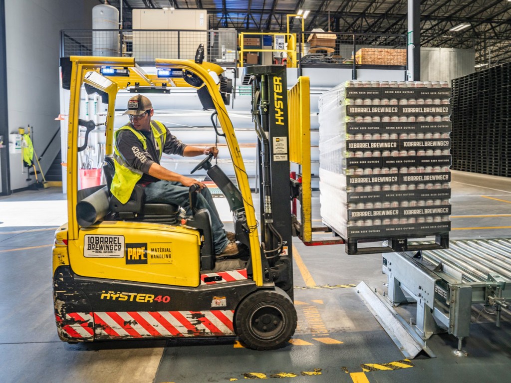 A shipping worker using a forklift