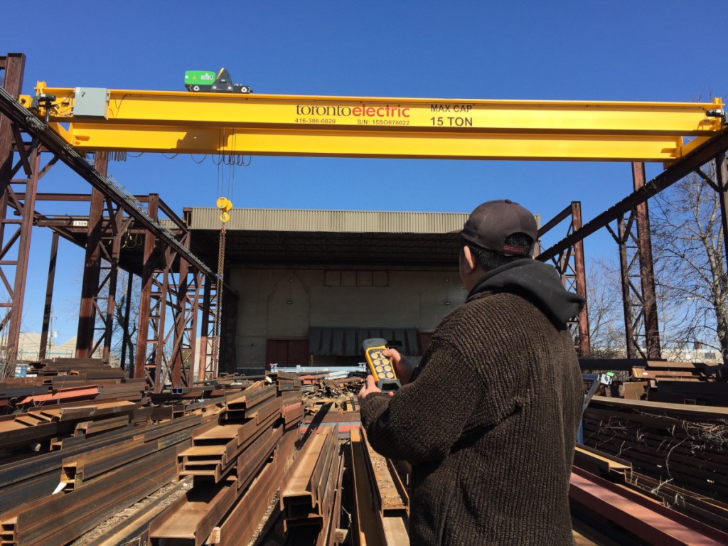 At Scarboro Steel Works Inc. two new remote-controlled Toronto Electric cranes have been installed in an outdoor area.